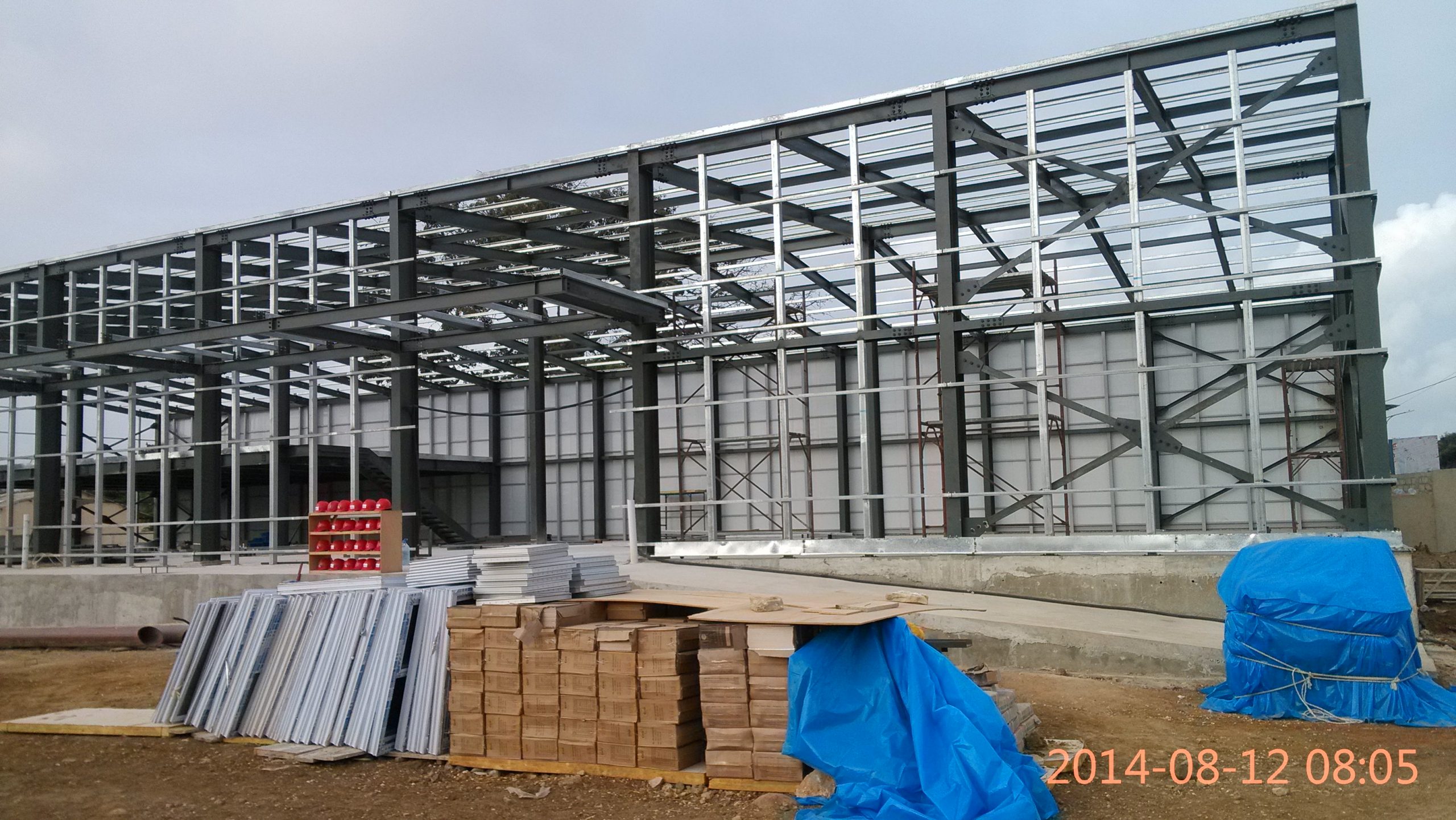 Steel skeleton of pioneering net zero energy steel structure hi-tech furniture factory and showroom workshop taking shape following groundbreaking on pioneering industrial campus planned to set new sustainability standards.