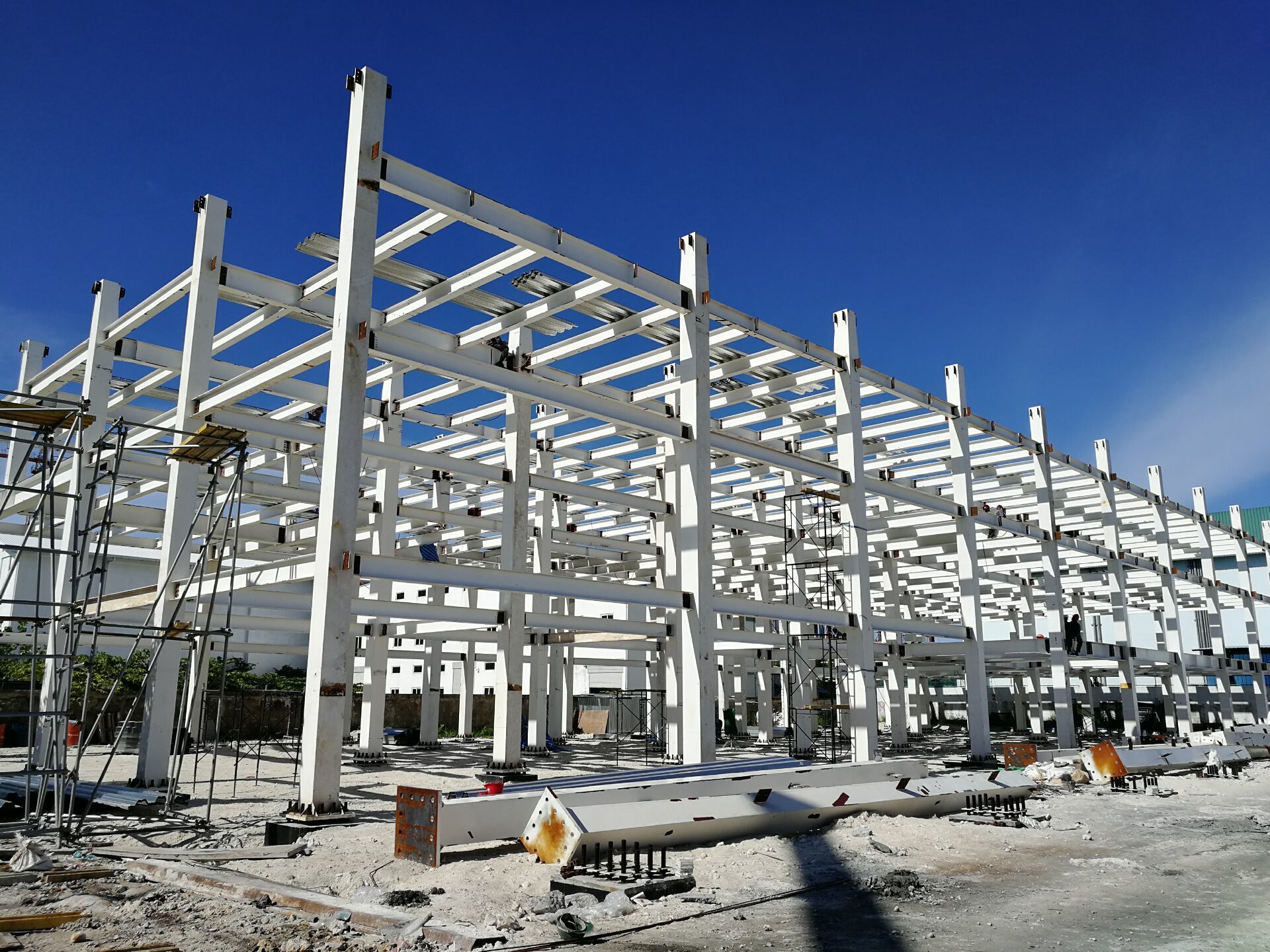 A new modern steel structure apartment complex features earthquake resistant modular prefabricated metal homes delivered within months.