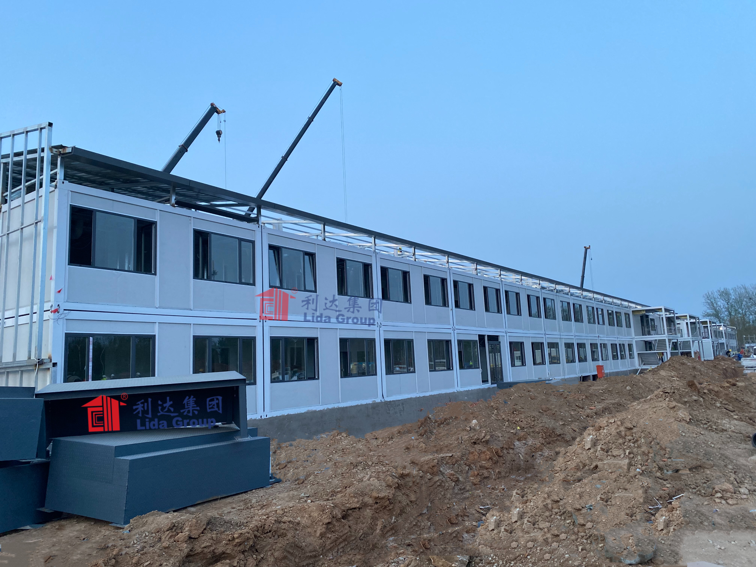 Case study shows how Lida Group built temporary shelters using recycled shipping containers to establish a prefab container housing facility for victims of forced labor